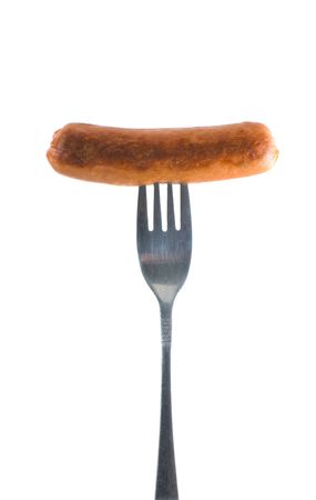 sausage on a fork in front of a white backgroundの写真素材