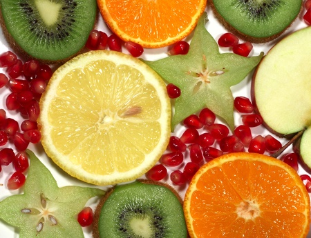 Fruit background with different cross sections of colorful fruitsの写真素材