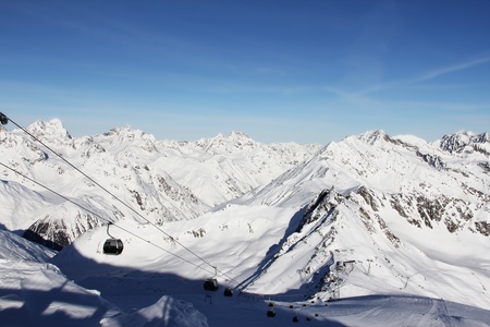 chairlift in beautiful winter snowy alpine mountains