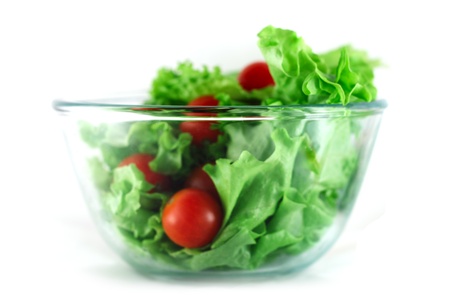  Lettuce and cherry tomatoes salad in transparent bowl isolated on white の写真素材