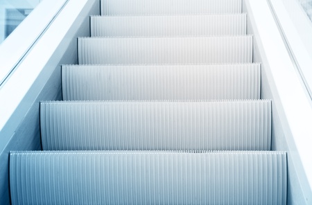 Clean beautiful blue escalator way up conceptの写真素材