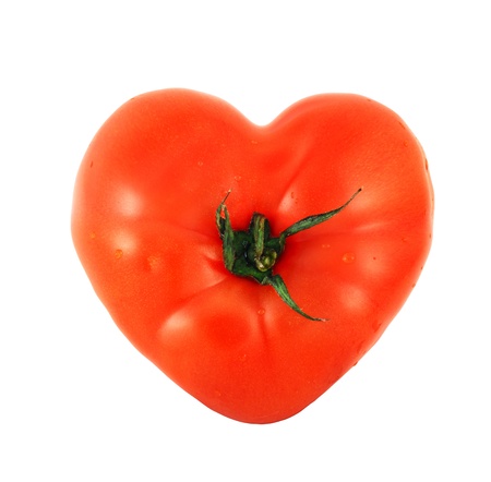 One tomato shaped like heart isolated on white backgroundの写真素材