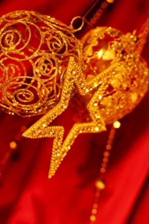 Golden christmas decoration on red fabric backgroundの写真素材