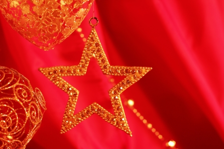 Golden christmas decoration on red fabric backgroundの写真素材