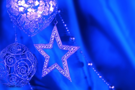 Silver christmas decoration on blue fabric backgroundの写真素材