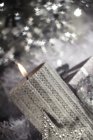 Christmas candle with gift and different silver decorationの写真素材