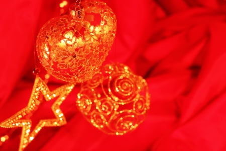 Golden christmas decoration on red fabric backgroundの写真素材