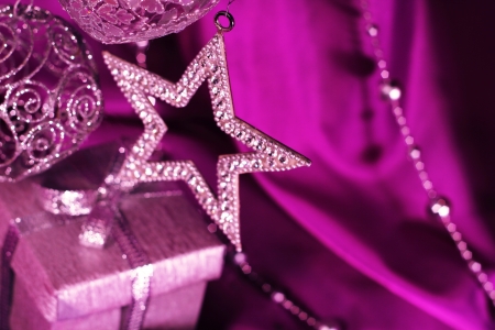 Silver christmas decoration and gift on purple fabric backgroundの写真素材