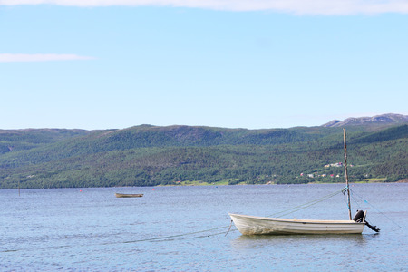 Landscape with sea, boat and mountains in northern Norwayの写真素材