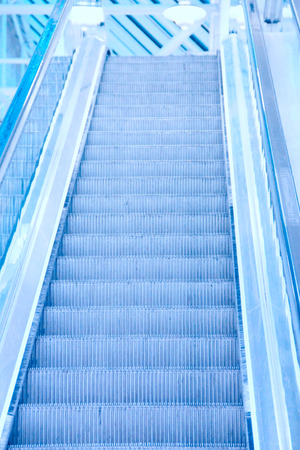 Perspective of escalator toned in blue colorの写真素材