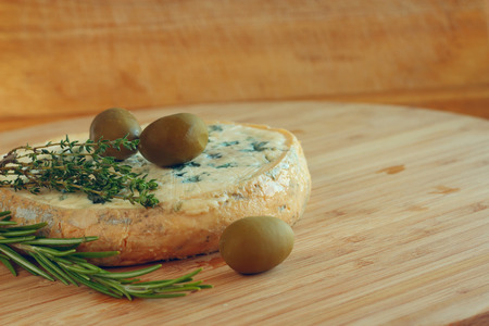 Cheese and Olives composition on wooden tableの写真素材