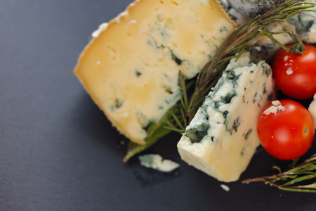 Roquefort cheese composition on dark background