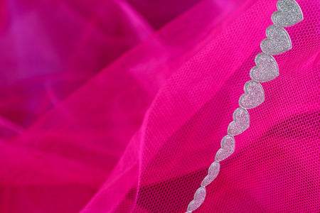 Heart ribbon on abstract pink fabric background, Valentines dayの写真素材