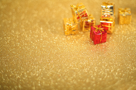 Holiday gift boxes on shiny golden background with copy spaceの写真素材