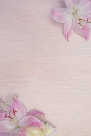 Lily flowers on wooden background with copy space, valentines day backgroundの写真素材