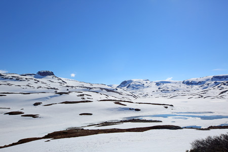 Spring valley landscape with mountains and melting snow, Norwayの写真素材