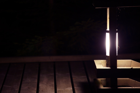Small electric outdoor lantern glowing at night close upの写真素材