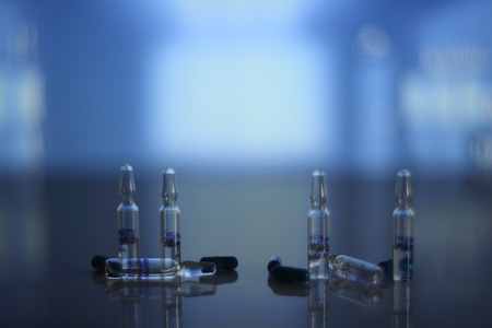 Medical pills and vials on table in hospitalの写真素材