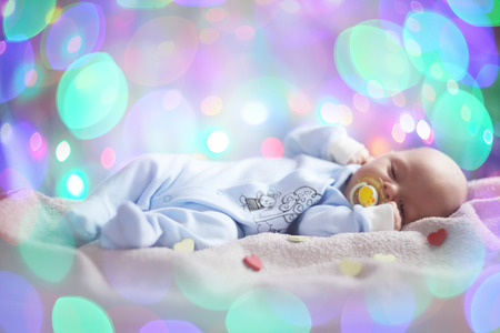 Love newborn baby Valentines day concept woth gearts and bokeh lightsの写真素材