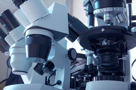 Group of various Microscopes in blue medicine light