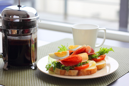 Healthy breakfast with sandwiches and coffee in french press, scandinavian styleの写真素材