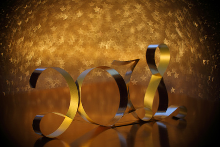 Golden ribbon shaped like 2018 new year concept on golden star shaoe bokeh backgroundの写真素材