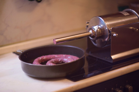 Close up of process of making homemade sausage at home with pressure machineの写真素材