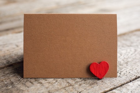 Blank brown paper greeting card with copy space for text and wooden heart, Valentines day conceptの写真素材