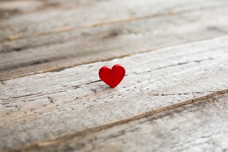 Small red heart on wooden background with copy spaceの写真素材