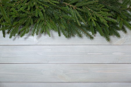 Christmas background with fir branches on white toned natural wooden plank background texture provence style for copy space for textの写真素材