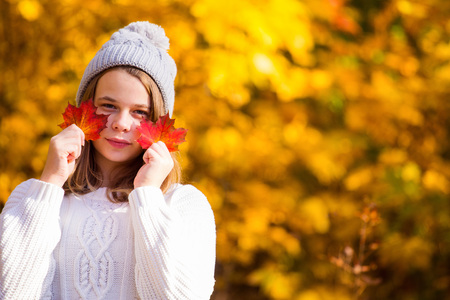 Portrait of pretty nice teenage girl in autumn park , background with copy space for text