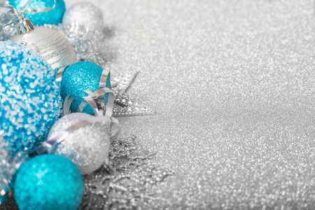 Christmas decoration of colorful glitter balls on silver glitter background with copy space for text new year card conceptの写真素材