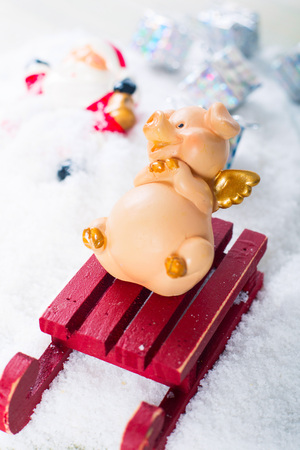 Funny naughty pig laughing at santa claus accident who fall from sleigh and lost giftsの写真素材