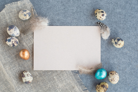 Easter greeting card with copy space for text and beautiful decor of eggs and feathers on fabric...