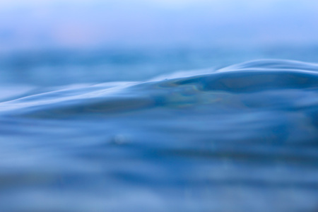Calm surface of the blue transparent smooth water abstract backgroundの写真素材