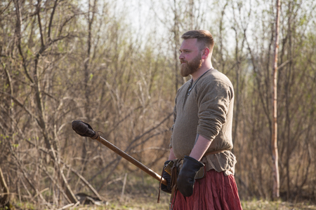 Portrait of Medieval slavic soldier standing outdoors with training spearの写真素材