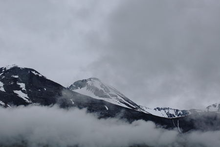Gloomy mountain landscape. Foggy mountains of Norwayの写真素材