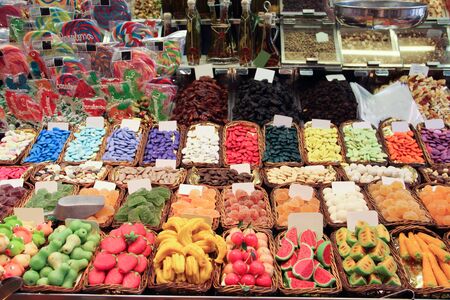 Assorted colorful jelly candies at the candy shop market stall color backgroundの写真素材