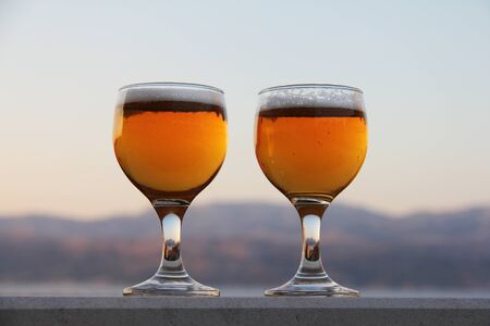 Two glasses of beer summer evening vacation relax conceptの写真素材
