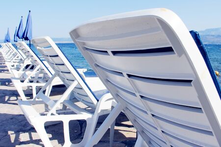 Rows of empty chaise-lounges over sea background, Supetar, Brac island, Croatiaの写真素材
