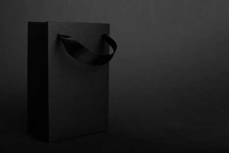 Black Friday blank empty paper bag with copy space for text and logo on dark background sale conceptの写真素材