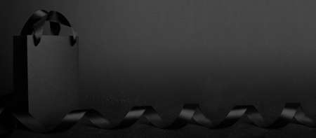 Black Friday blank empty paper bag with copy space for text and logo on dark background sale concept banner backgroundsの写真素材