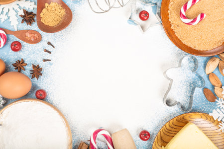 Christmas gingerbread cookies cooking background flat lay top view template with copy space for text. Baking utensils, spices and food ingredients on blue backgroundの写真素材