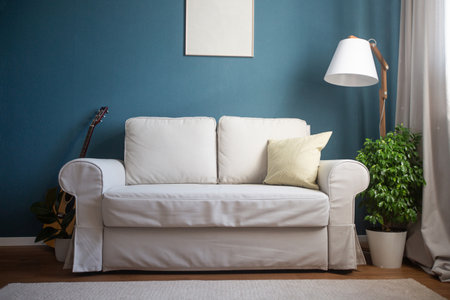 Classical scandinavian design with blue walls and night gray sofa