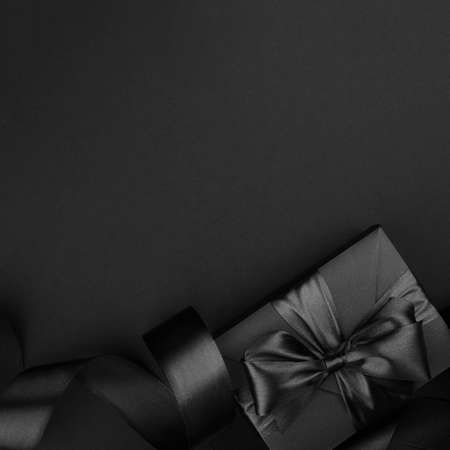 Black friday sale background with gift present box and curly ribbon with copy space for text adの写真素材