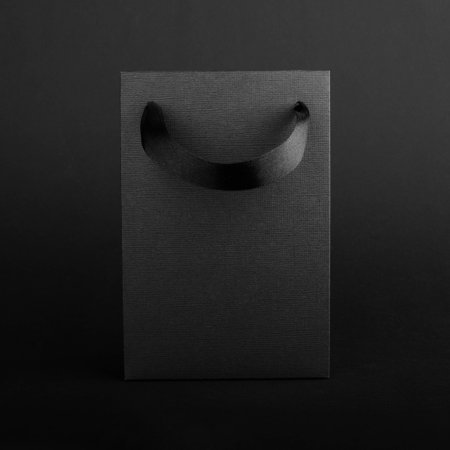 Black Friday blank empty paper bag with copy space for text and logo on dark background sale conceptの写真素材