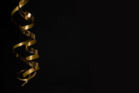 Black Friday sale background with curly golden ribbon luxury special offer design concept, copy space for text contentの写真素材