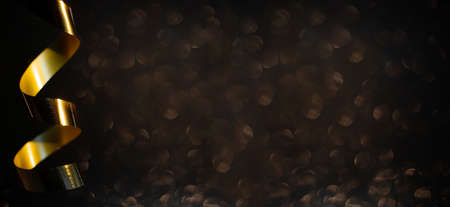 Golden curly ribbon on black glitter background black friday design backgroundの写真素材