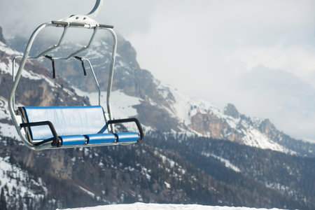 Ski lift chairs at ski resort in winter mountainsの写真素材