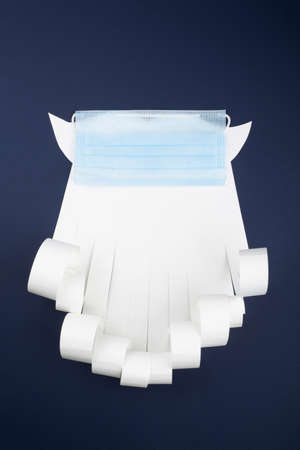 Santa Claus beard with face mask on blue background, creative minimal concept of Christmas and New Year safe celebrationの写真素材